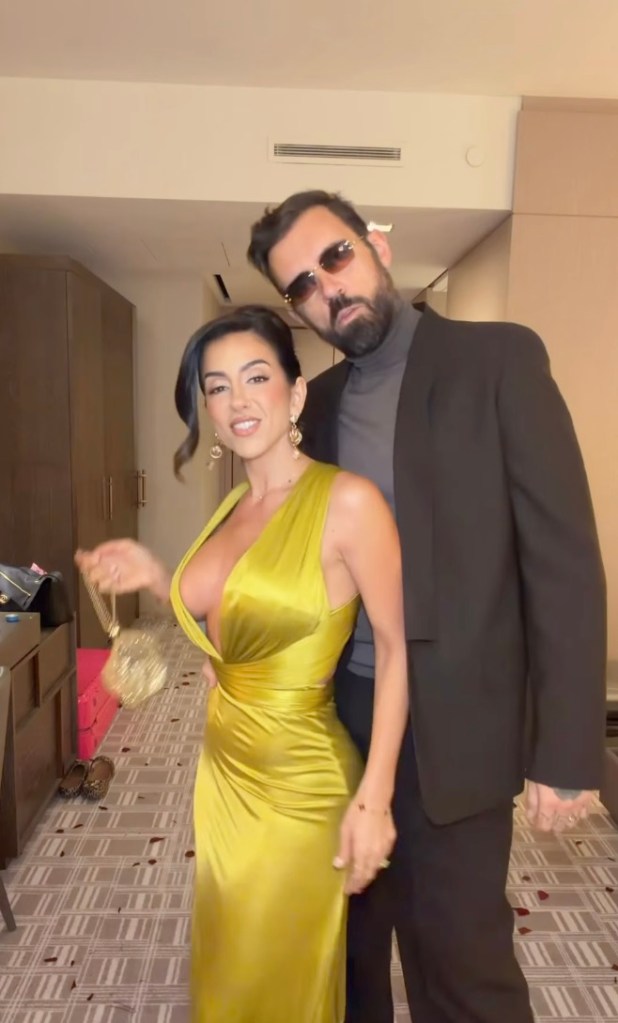 Adam22 and Lena the Plug pose together indoors.
