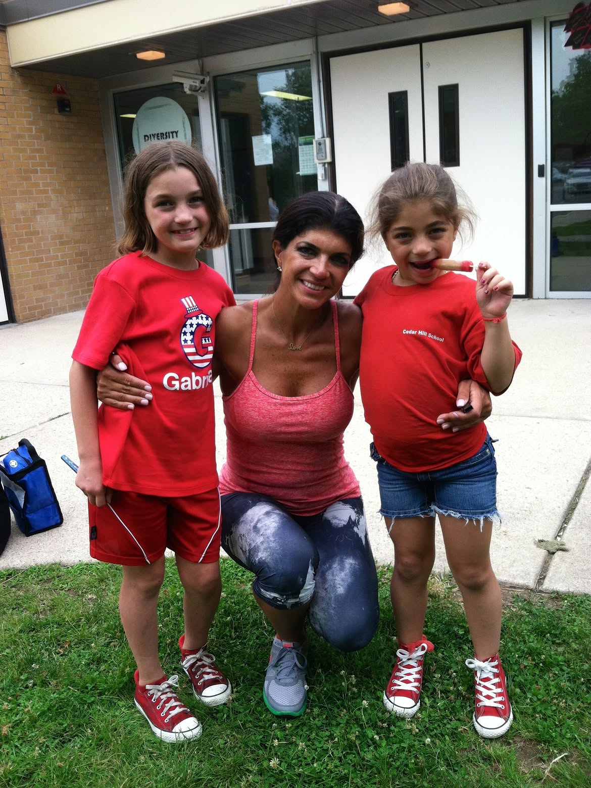 Teresa Giudice poses with her daughters Milania and Gabriella outside a school building.