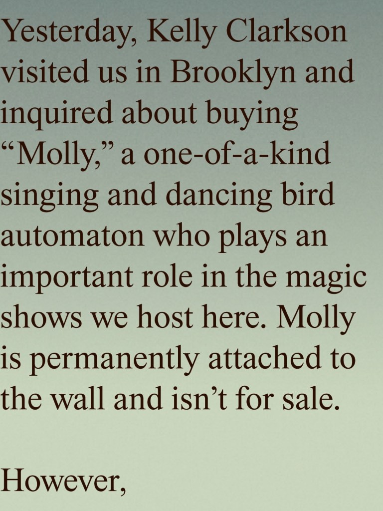 Text stating that Kelly Clarkson visited a Brooklyn store and tried to buy a singing and dancing bird automaton named Molly, which is permanently attached to the wall and not for sale.
