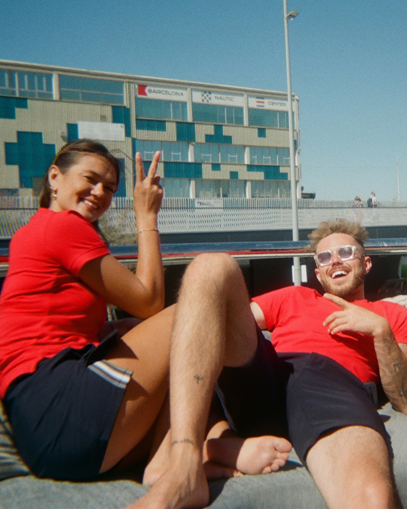 Nathan Gallagher and Gael Cameron pose together outdoors in matching red shirts.