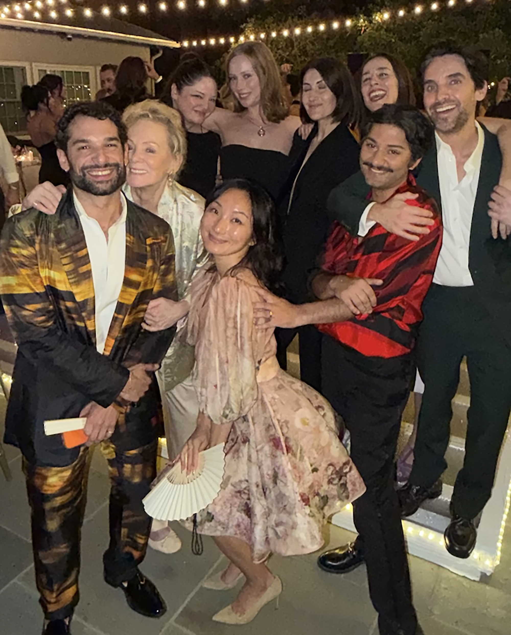Cast members of 'Hacks' pose together at a wedding.