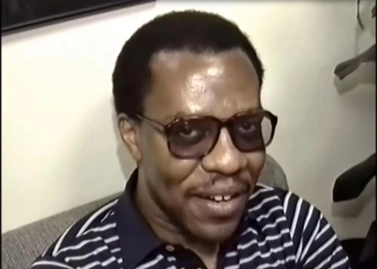 Ronnie Benjamin, also known as Big Black, wearing glasses and a striped shirt.