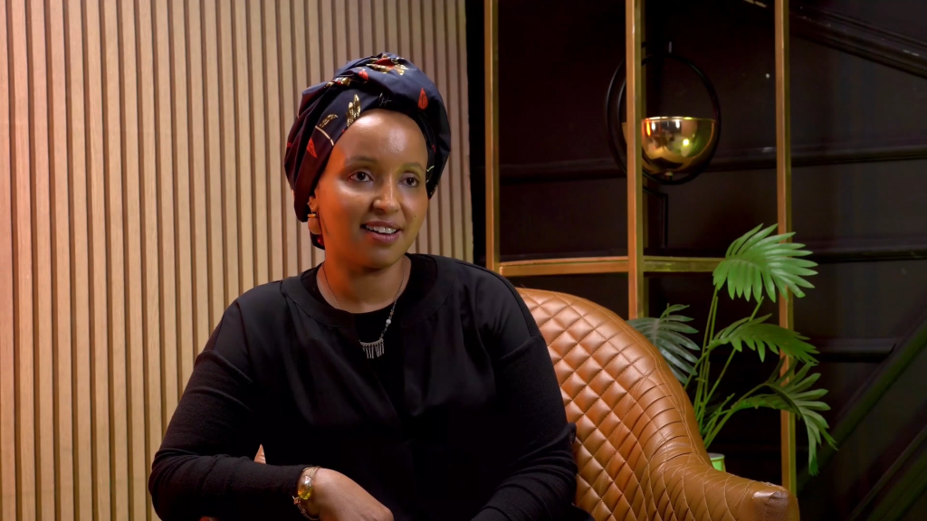 Sahra Noor sitting in an armchair during an interview.