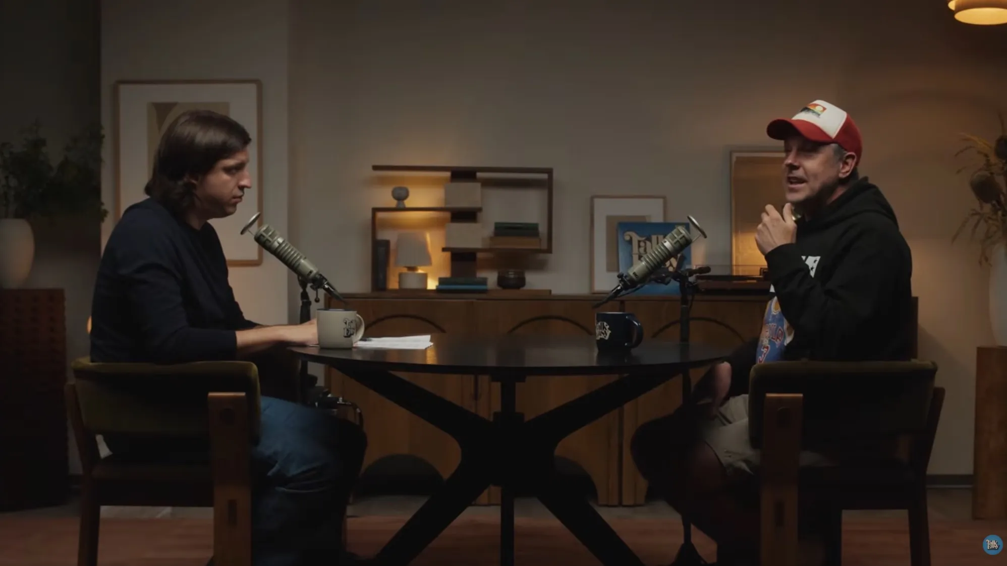 Jason Sudeikis being interviewed in a podcast setup.
