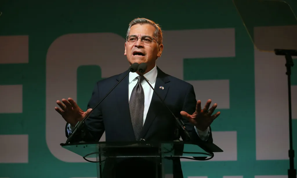 Xavier Becerra speaks at a podium during his election night party.