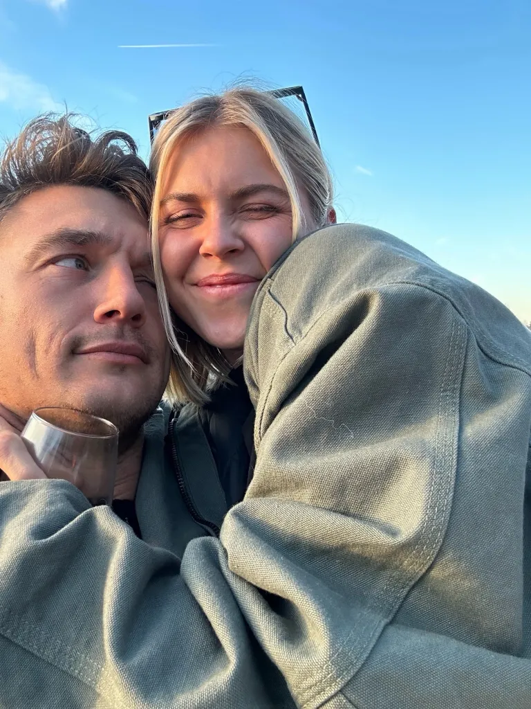 Tyler Cameron and fiancée Tate Madden embrace outdoors.