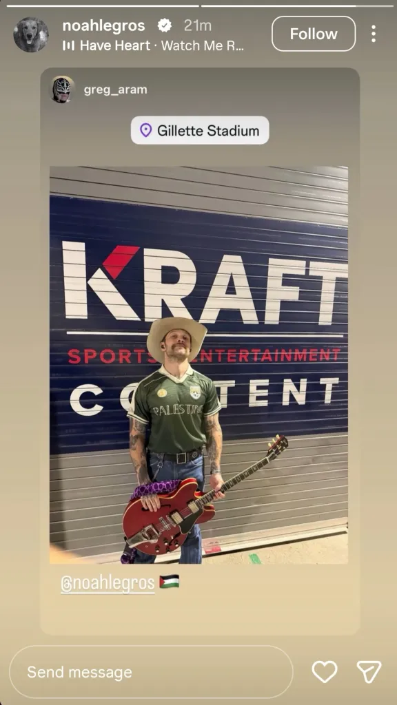 Guitarist Noah Legros wearing a Palestine jersey while holding a red electric guitar at Gillette Stadium.